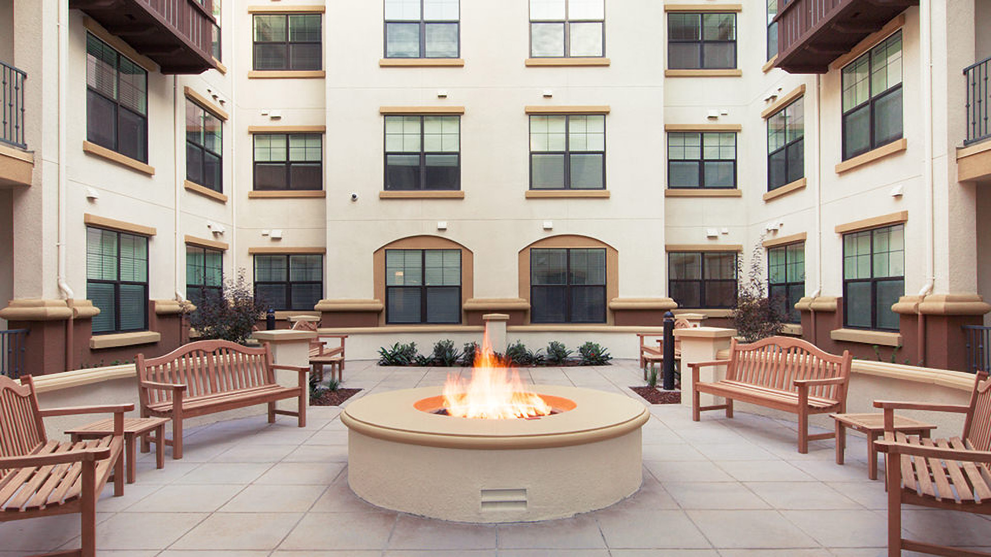 Outdoor fire pit and seating area at Tuscany Santa Clara